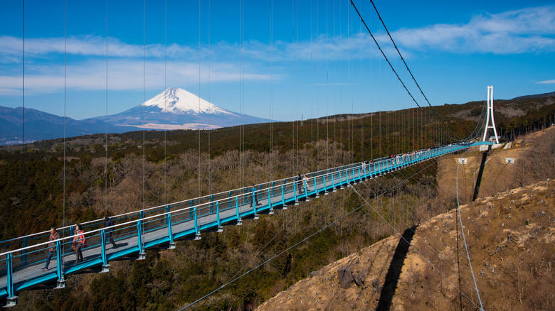 People walk across Mishima Skywalk