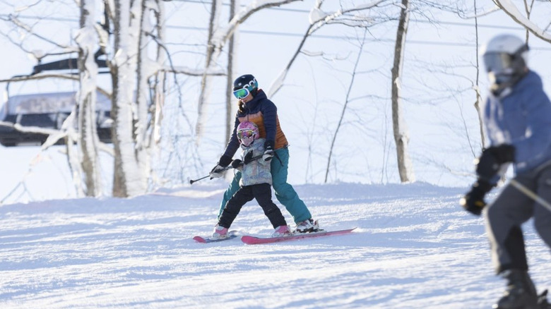 A mother and daughter skiing in The Highlands