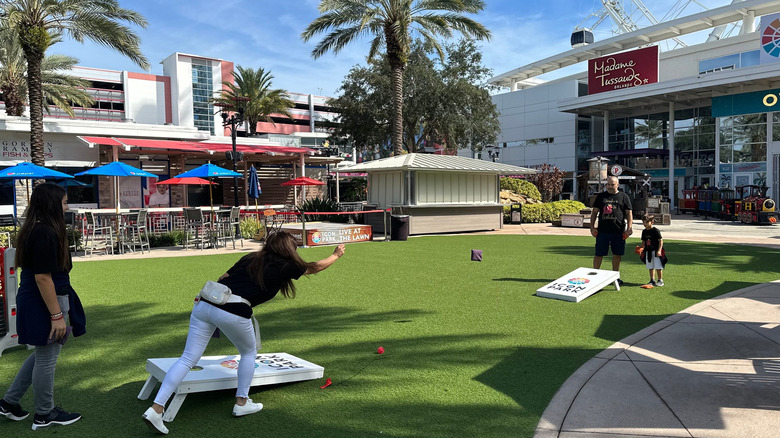 Icon Park visitors play cornhole