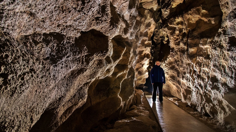 visitor exploring Pál-völgyi Cave