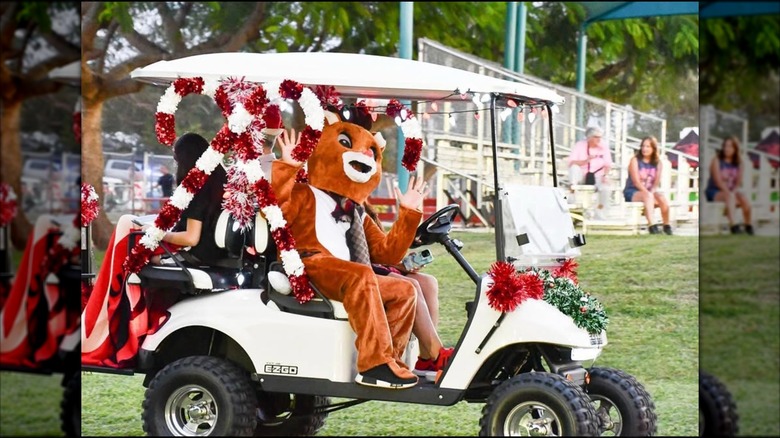 person in reindeer costume participates in the annual golf cart parade