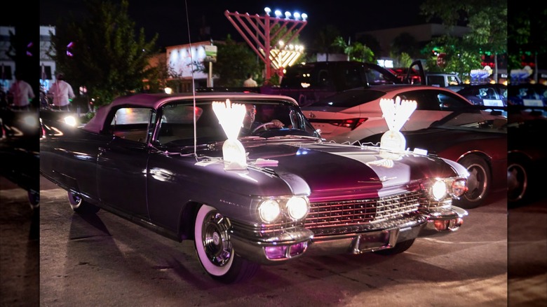 A car decorated with a giant menorah