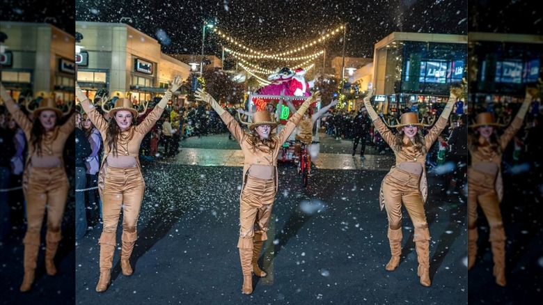 Dancers in the Summerlin, Nevada holiday parade pose in front of a Santa float