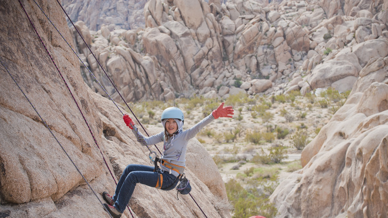 Kid rock climbing at Joshua Tree NP