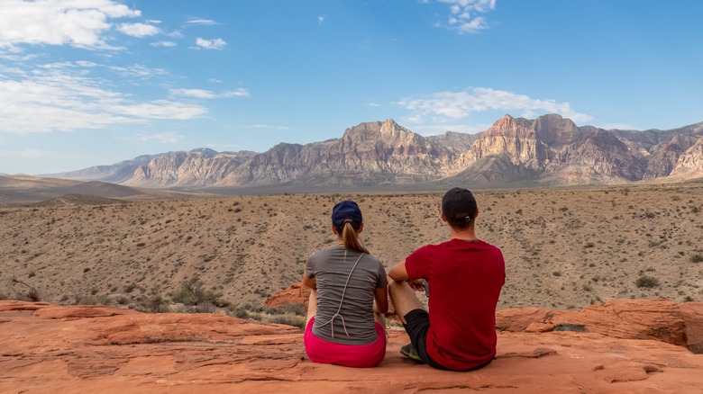 Two people sitting at an overlook in Red Rock Canyon National Conservation Area