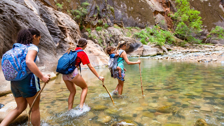 Three women hiking in The Narrows at Zion National Park