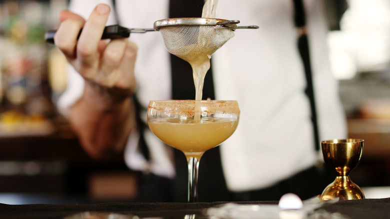 Bartender pouring a cocktail