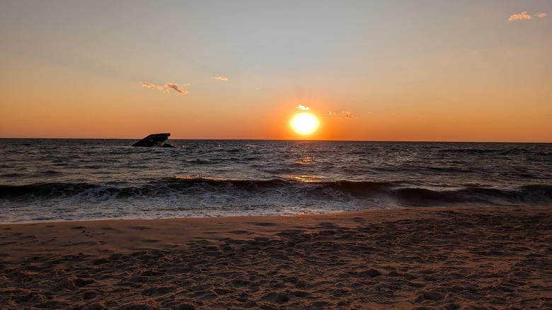 Sun setting over Delaware Bay as viewed from Sunset Beach, Cape May, New Jersey