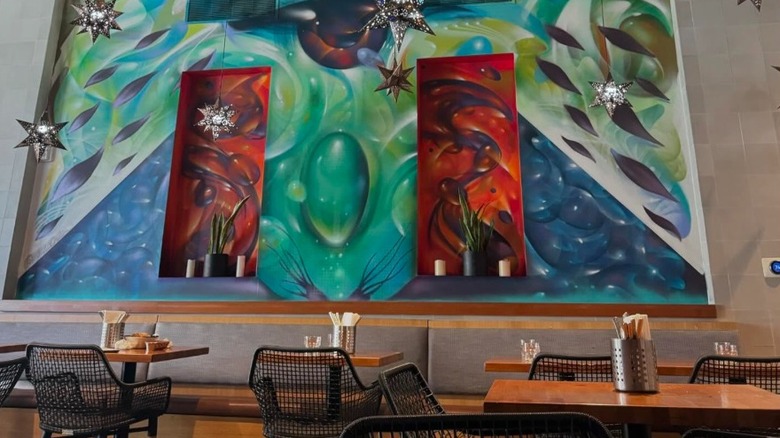 Wall art and tables inside Guerrilla Tacos