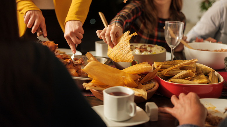 Family eating tamales at dining table