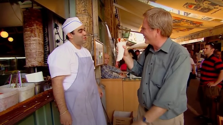 Rick Steves being handed a gyro