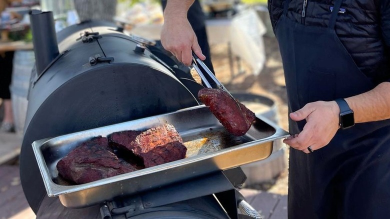 Man serving beef with tongs at Jeffry's Wine Country BBQ