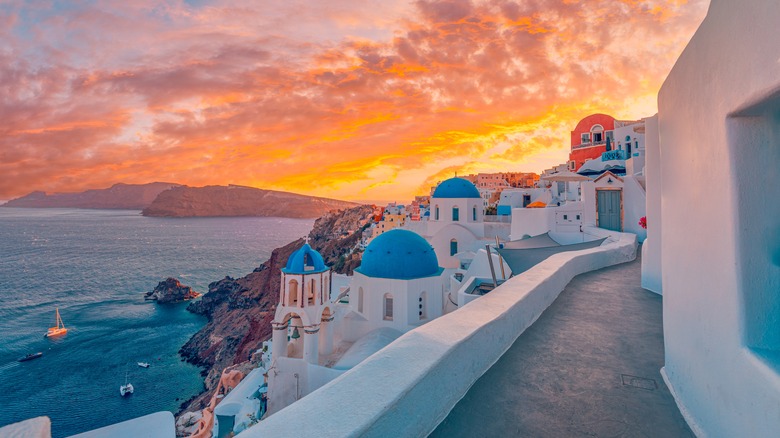 The blue-domed churches of Santorini as the sun sets.