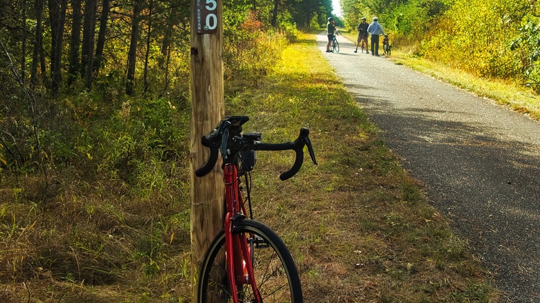 Bicycle resting on mile marker on Paul Bunyan Trail