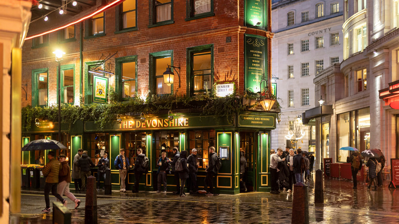 A pub-lined street in London on a rainy day