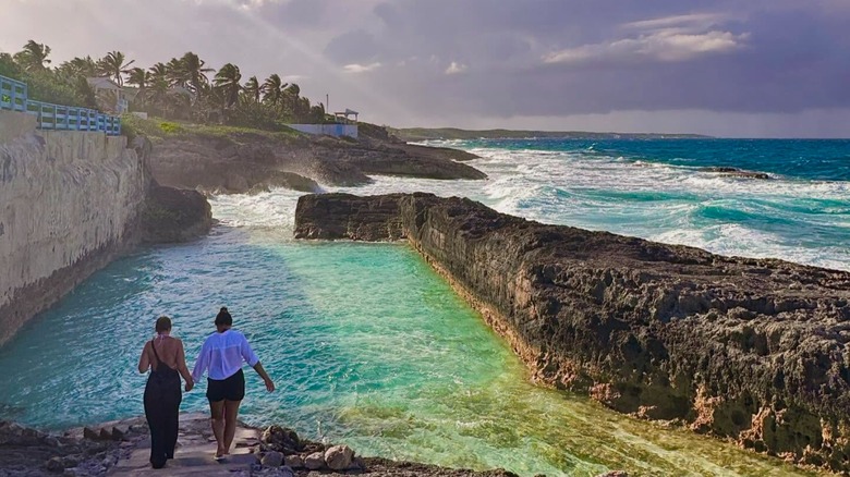 Two people by an exotic pool in the Bahamas