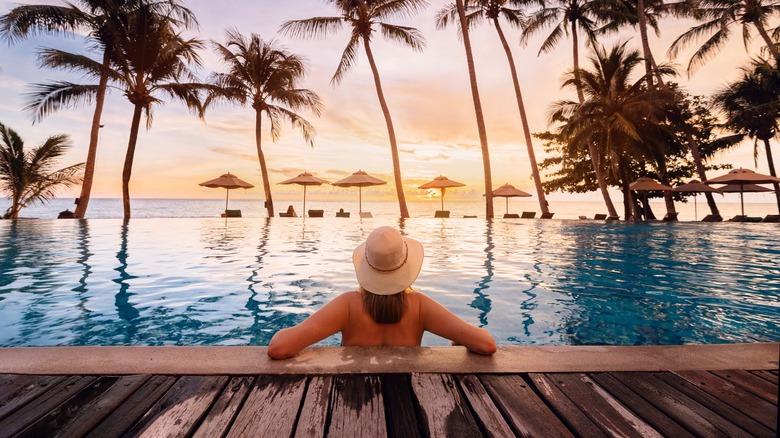 Woman relaxing in a tropical swimming pool