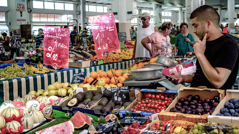 People shopping for fresh produce at Marché Forville in Cannes, France