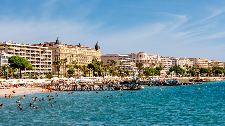 The blue mediterranean sea against the beach and hotels in Cannes, France