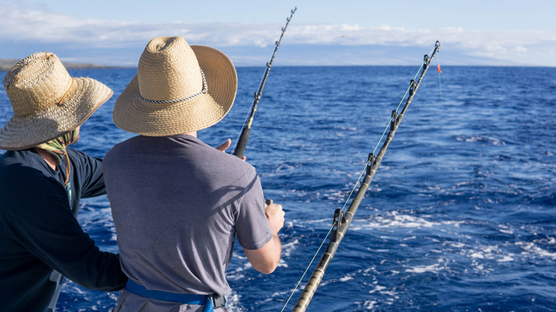 two people in hats fishing