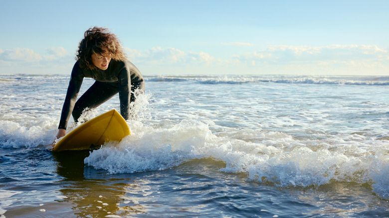 woman surfing in ocean