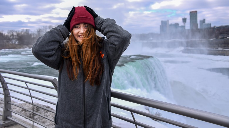 Woman smiling at a wintery Niagara Falls