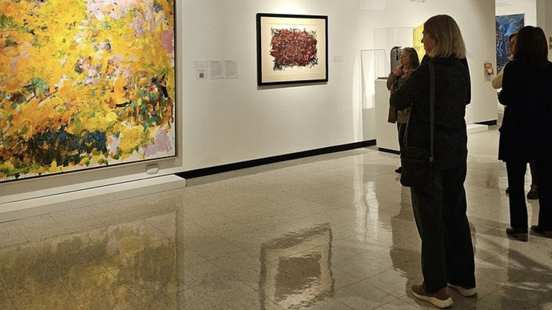 people observe a painting at the Castellani Art Museum