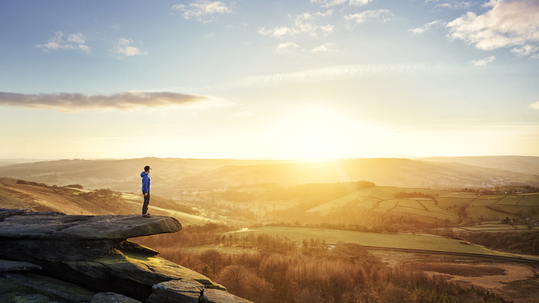 Hiker in the Peak District UK at sunset