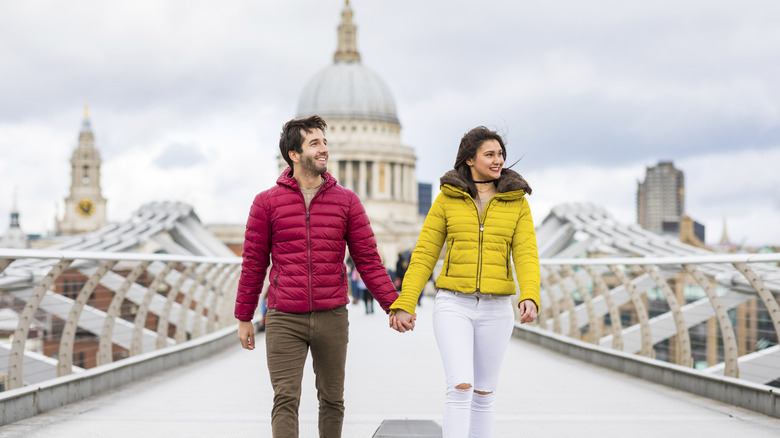 Couple walking on the Millennium Bridge