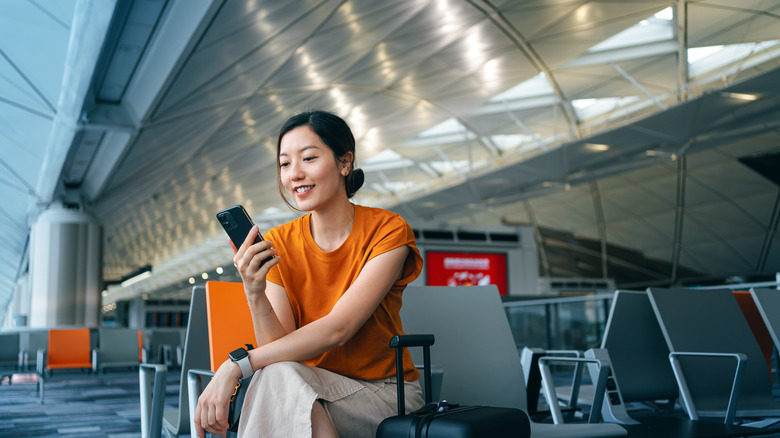 Woman using a cellphone at the airport