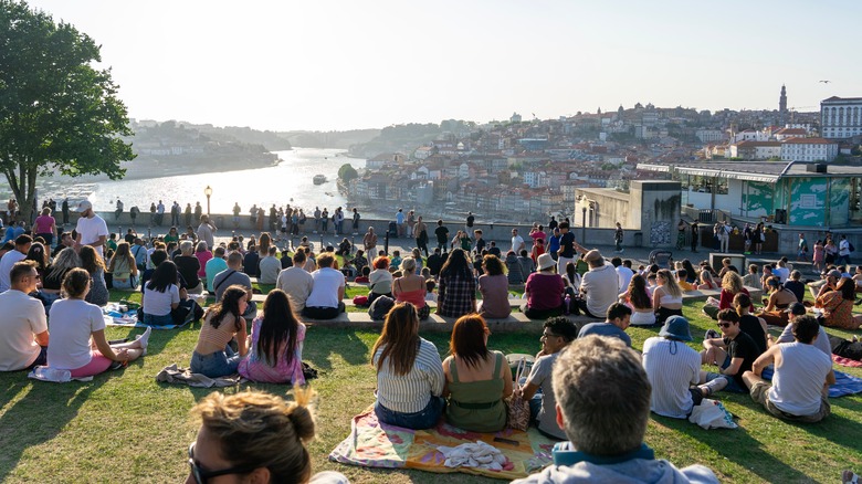 Folks gather to watch the sun set over Porto