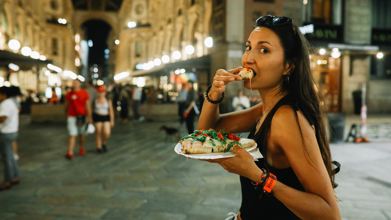 Girl eating in Milan