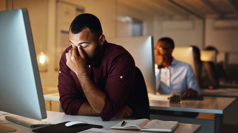 Man, stressed in front of computer