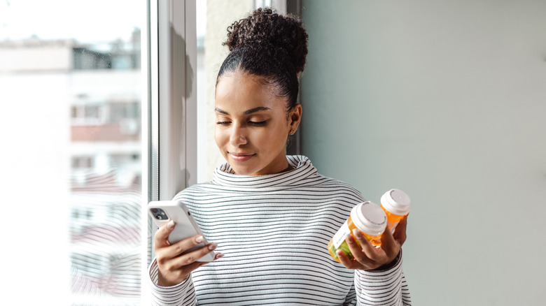 a woman researching prescription medication on phone