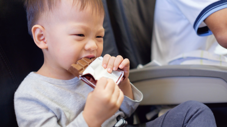 Child eating a snack on an airplane