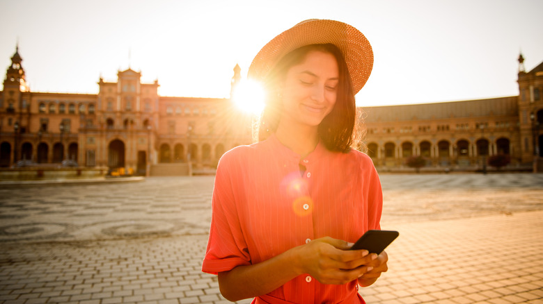 Woman using phone app during travels