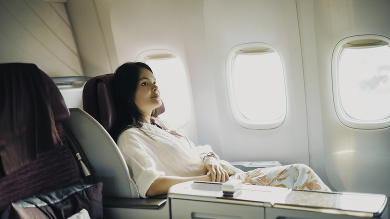 A woman sitting in a first class seat