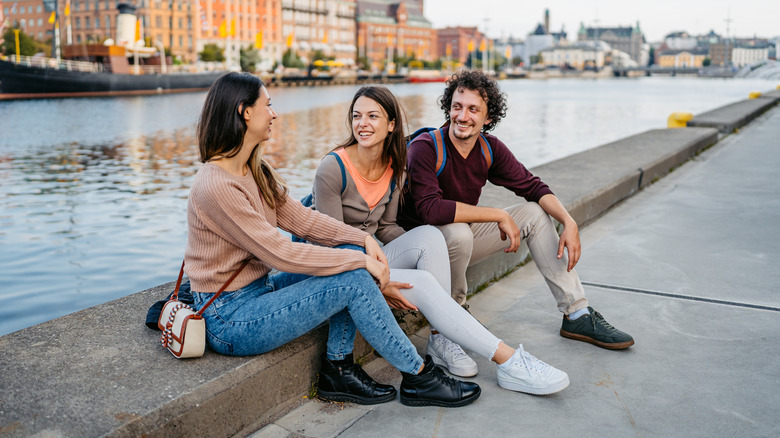 A group of friends sitting near a river in Sweden