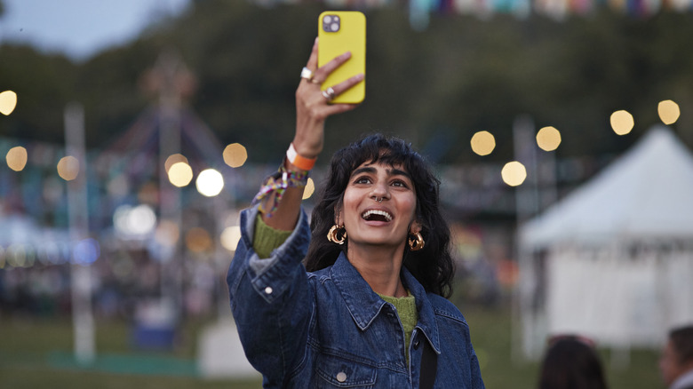 Woman taking photo with phone