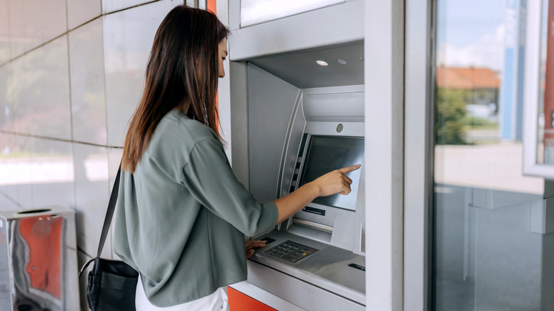 Woman using ATM