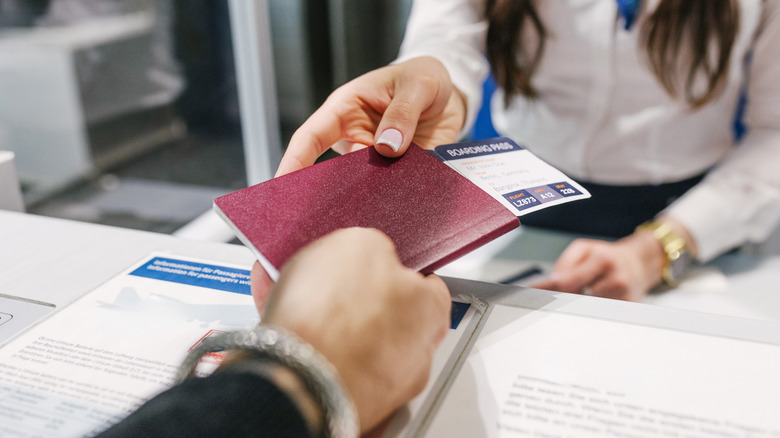 Handing off a passport and boarding pass