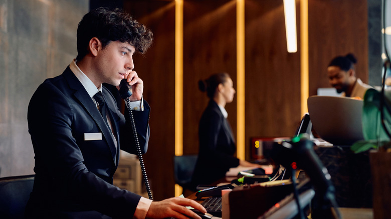 Hotel clerk taking a phone call