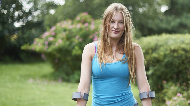 A young woman with crutches outdoors