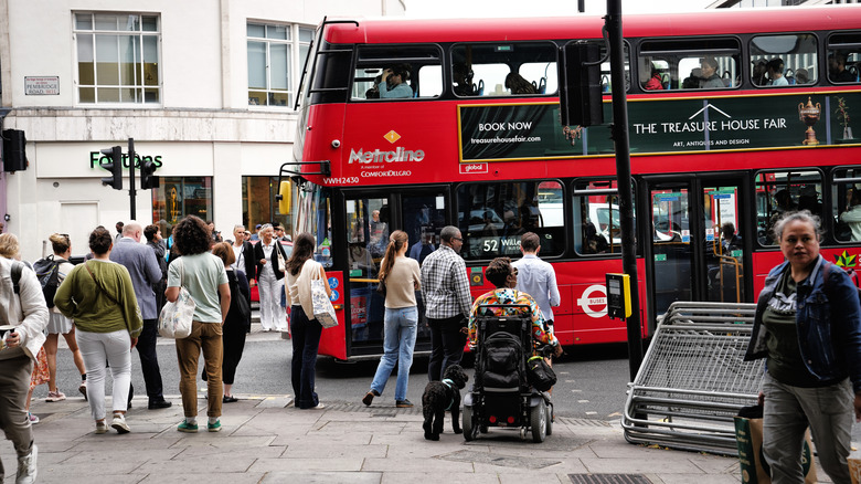 A person in a wheelchair approaches london double decker bus