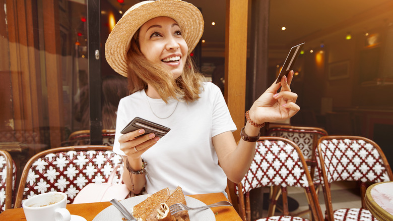 Person paying for meal with credit card