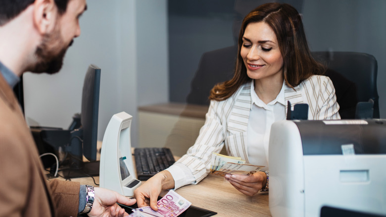 Bank teller exchanging euros