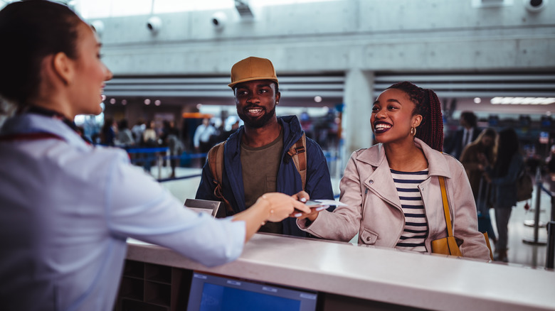 Couple talking to an airport employee