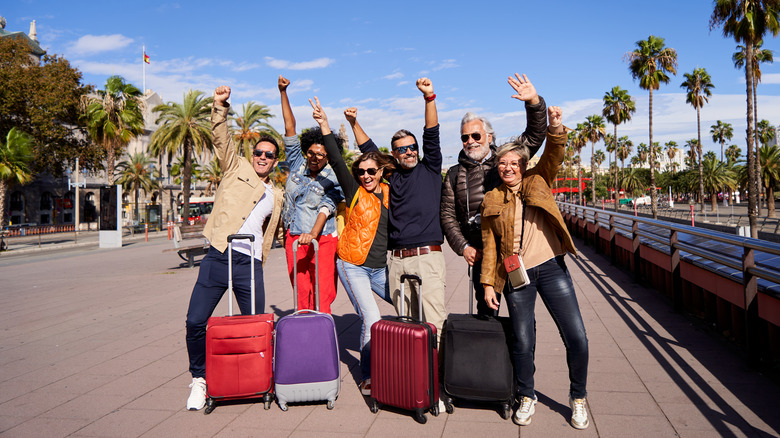 cheering travelers with luggage