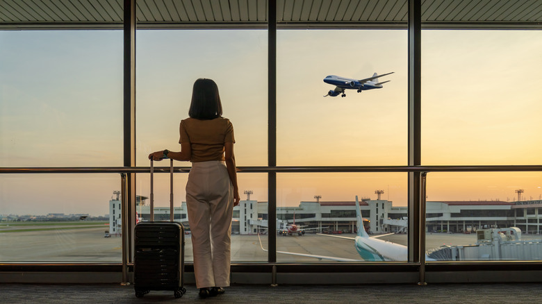 traveler watches plane arriving