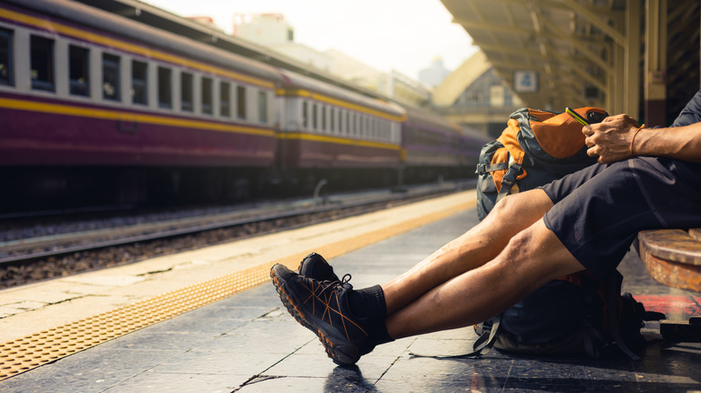 Backpacker in train station